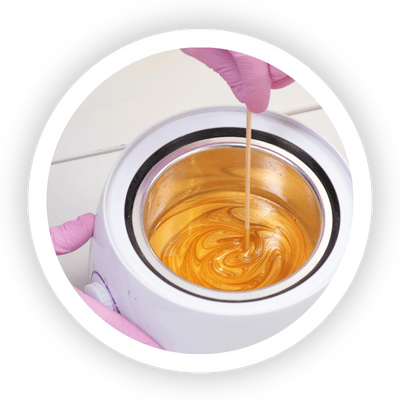 Annie's Beauty and Body Waxing 16 Hard wax used for professional hair removal on sensitive areas, melting in a wax warmer.