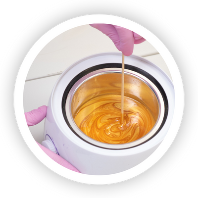 Annie's Beauty and Body Waxing 13 Hard wax used for professional hair removal on sensitive areas, melting in a wax warmer.